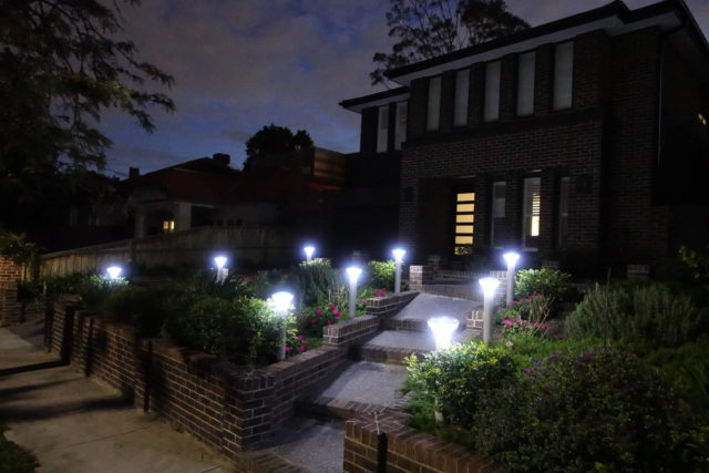 Building facade with Solar Bollards lighting up the driveway and walkpath.